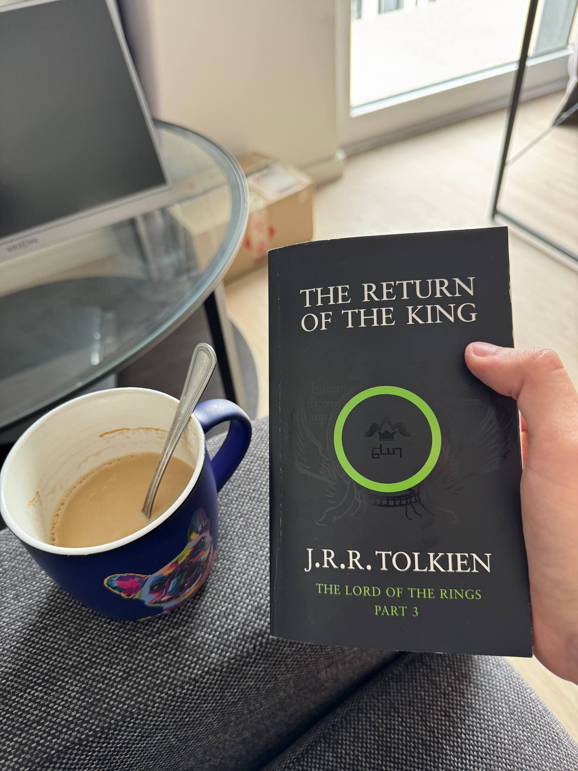 Lord of the Rings book and a cup of coffee